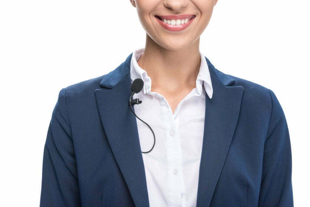 Smiling female newscaster with lavalier microphone for high-quality audio recording