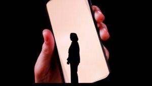 a hand holding a white object