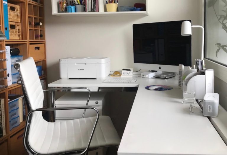 a white desk with a computer on it