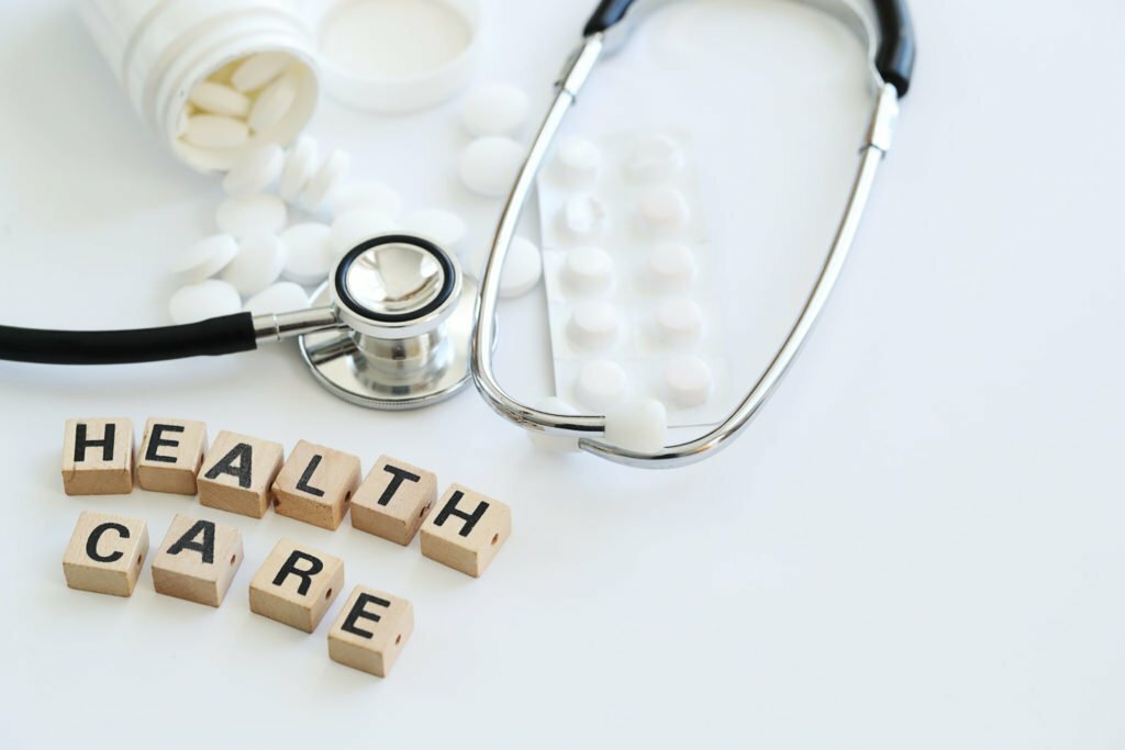 a medical stethoscope next to pills