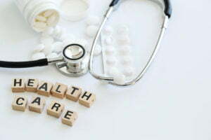 a medical stethoscope next to pills