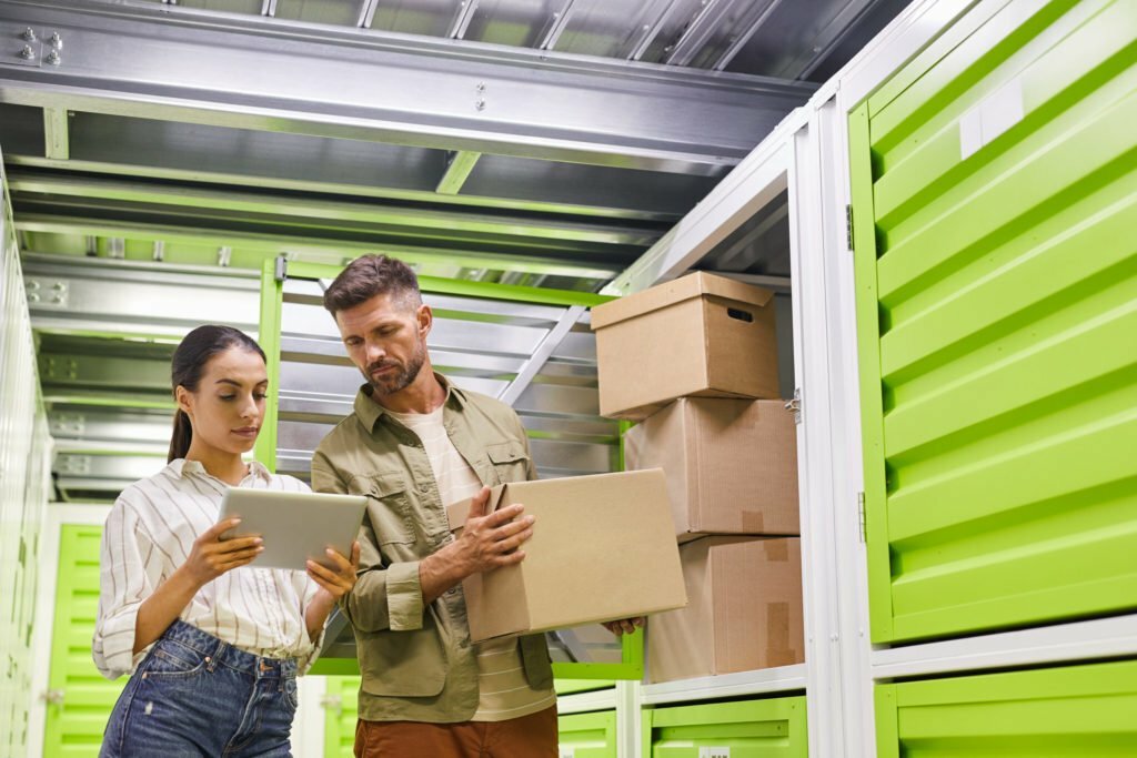 Couple Packing Boxes in Storage Unit