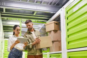 Couple Packing Boxes in Storage Unit