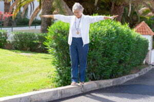 happy senior woman walks on the curb with her arms 2022 01 31 00 52 07 utc scaled