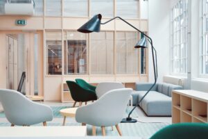 a room with chairs and a lamp