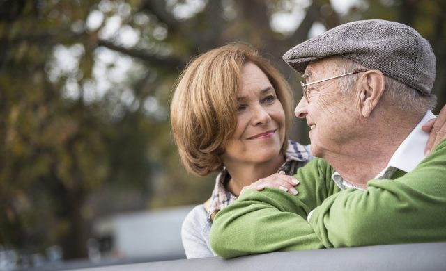Confident senior man with daughter outdoors
