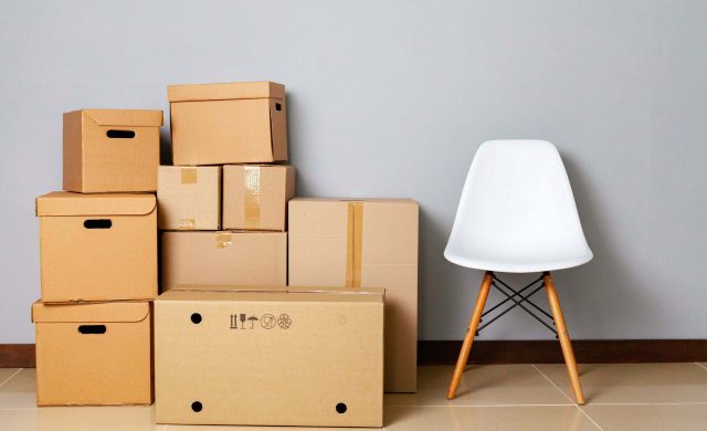 Moving boxes with packed stuff and chair for moving