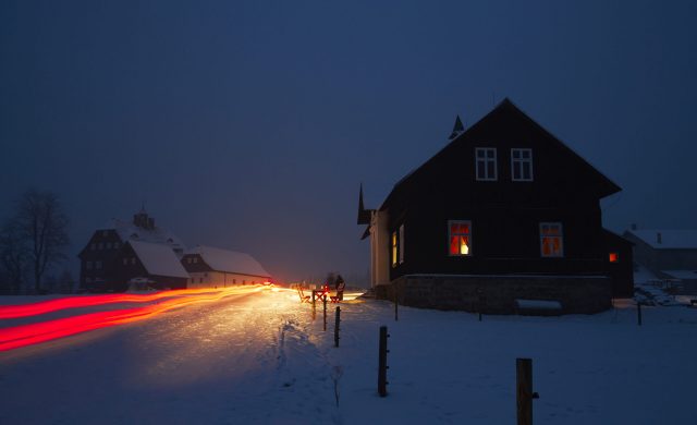 Night in mountains - wooden house in winter landscape
