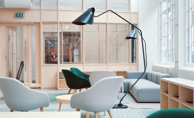 a room with chairs and a lamp