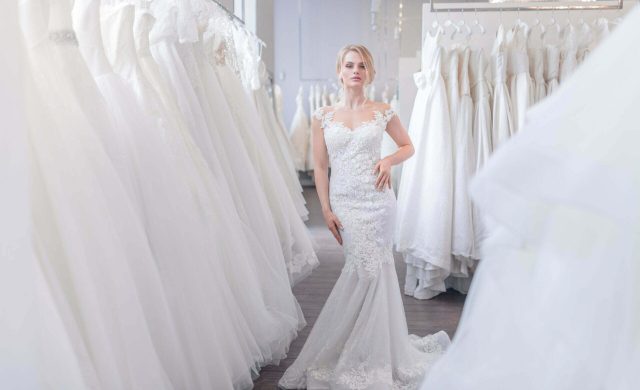 Beautiful woman in a wedding dress in the store